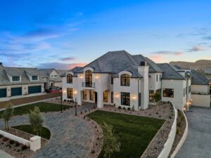 Custom luxury home by RL Wyman in St. George, Utah, featuring elegant architecture, landscaped front yard, and twilight sky backdrop.