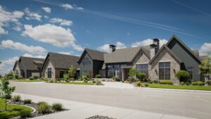 Row of custom homes featuring stone exteriors and gabled roofs in a landscaped setting, showcasing the craftsmanship of RL Wyman Design + Create in St. George, Utah.